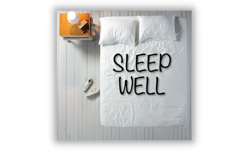 Beautifully made bed with sign sleep well